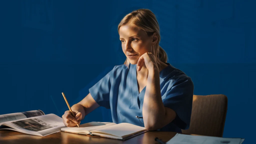 HIV Diploma Exam in South Africa: Requirements, Structure, and Preparation : A medical student sits at a desk studying and taking notes in preparation for the HIV Diploma Examination in South Africa, surrounded by textbooks in a calm, focused setting.